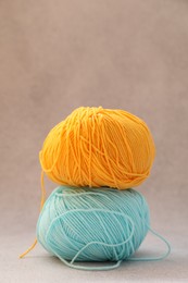 Two soft skeins of yarn on beige background