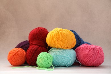 Photo of Many soft skeins of yarn on beige background