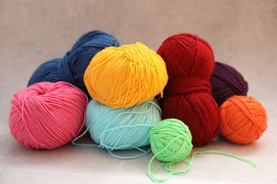 Photo of Many soft skeins of yarn on beige background