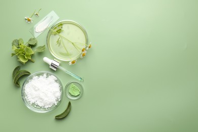 Petri dishes with leaves, chamomile flowers and cosmetic products on green background, flat lay. Space for text