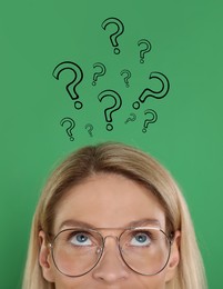 Image of Woman and question marks on green background, closeup