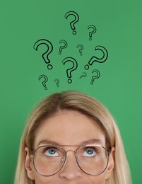 Woman and question marks on green background, closeup