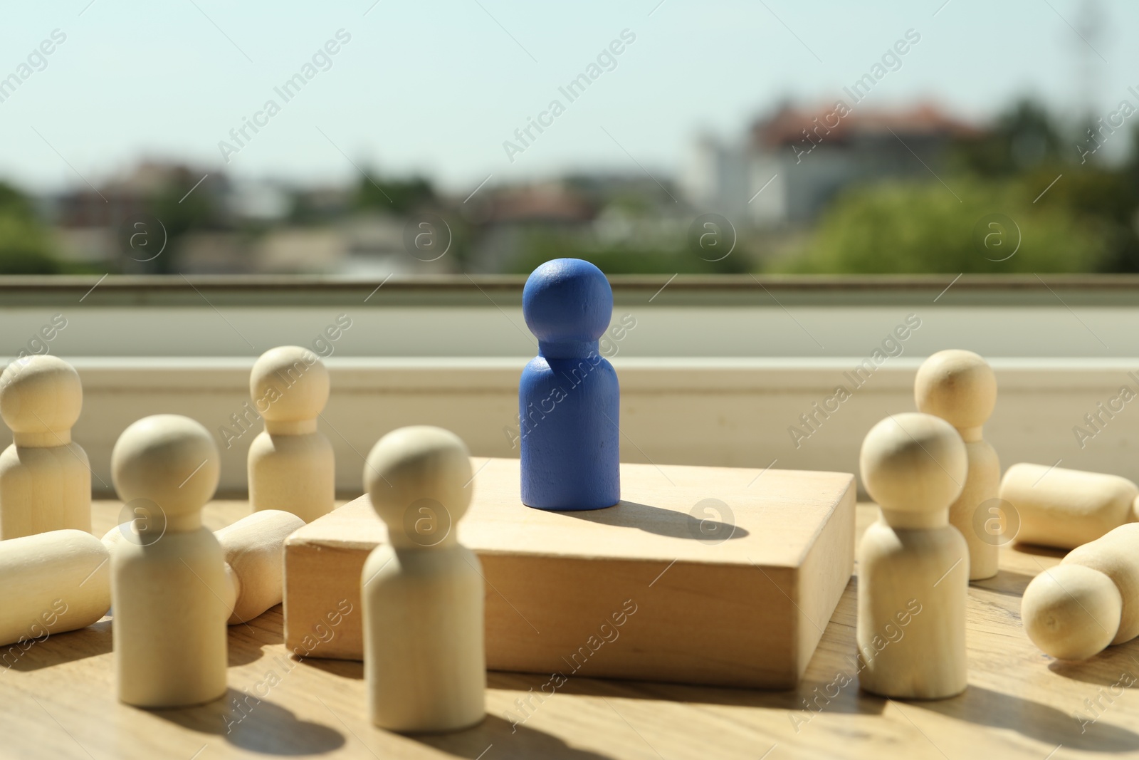 Photo of Blue piece among wooden ones on windowsill