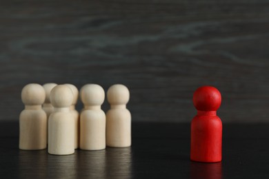 Photo of Red piece near wooden ones on black table