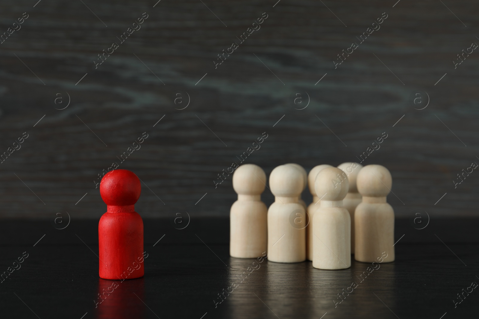 Photo of Red piece near wooden ones on black table