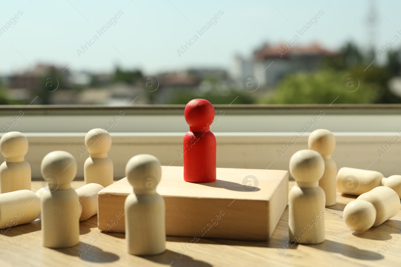 Photo of Red piece among wooden ones on windowsill