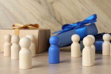 Blue piece among wooden ones on table