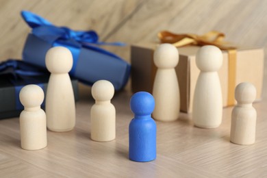 Blue piece among wooden ones on table