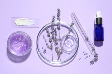 Petri dishes with lavender flowers and cosmetic products on violet background, flat lay