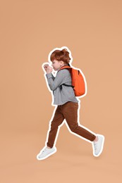 Cute school child with backpack running on dark beige background