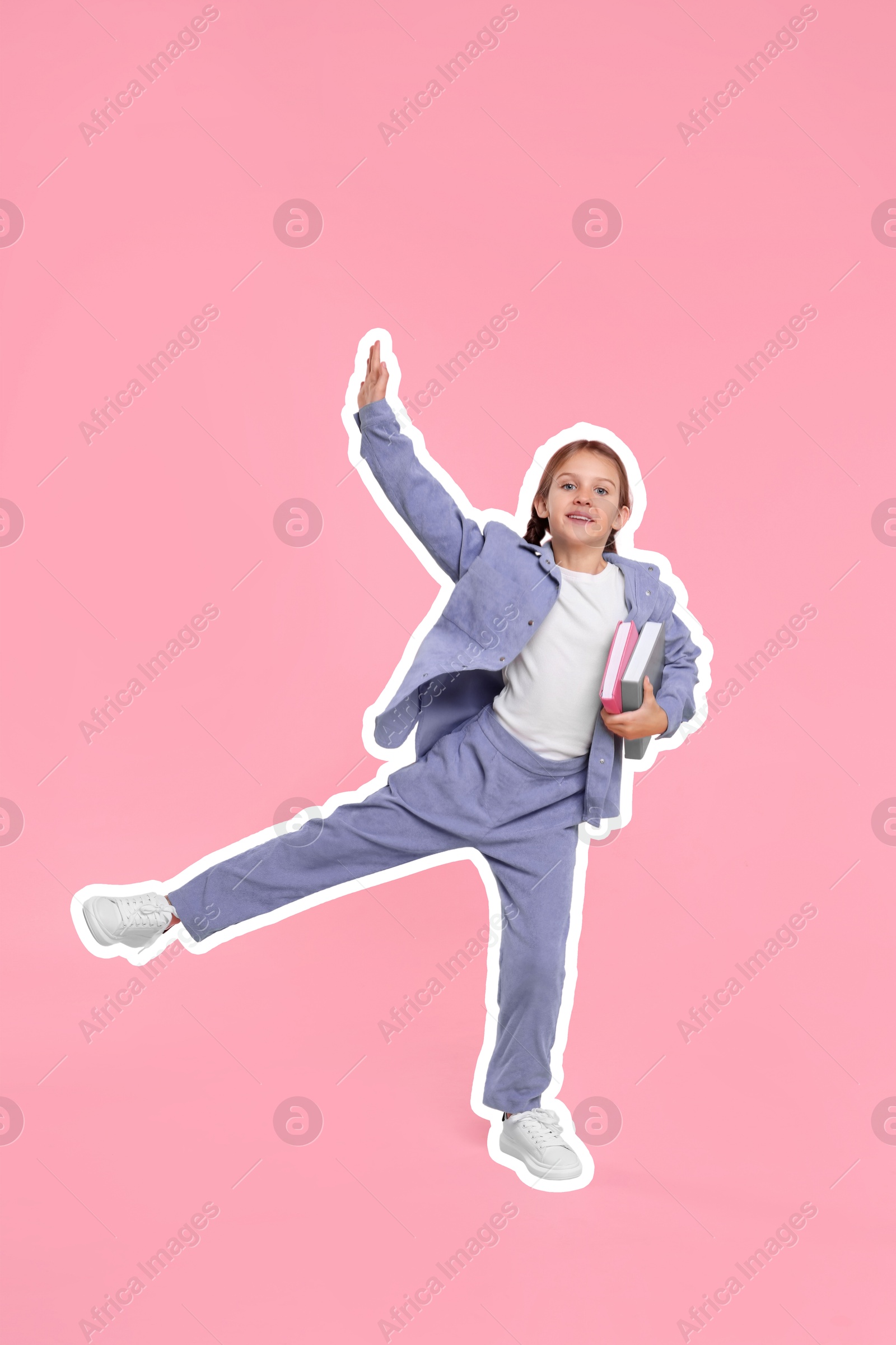 Image of Smiling school child with books on pink background