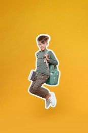 Image of Cute school child with book jumping on orange background