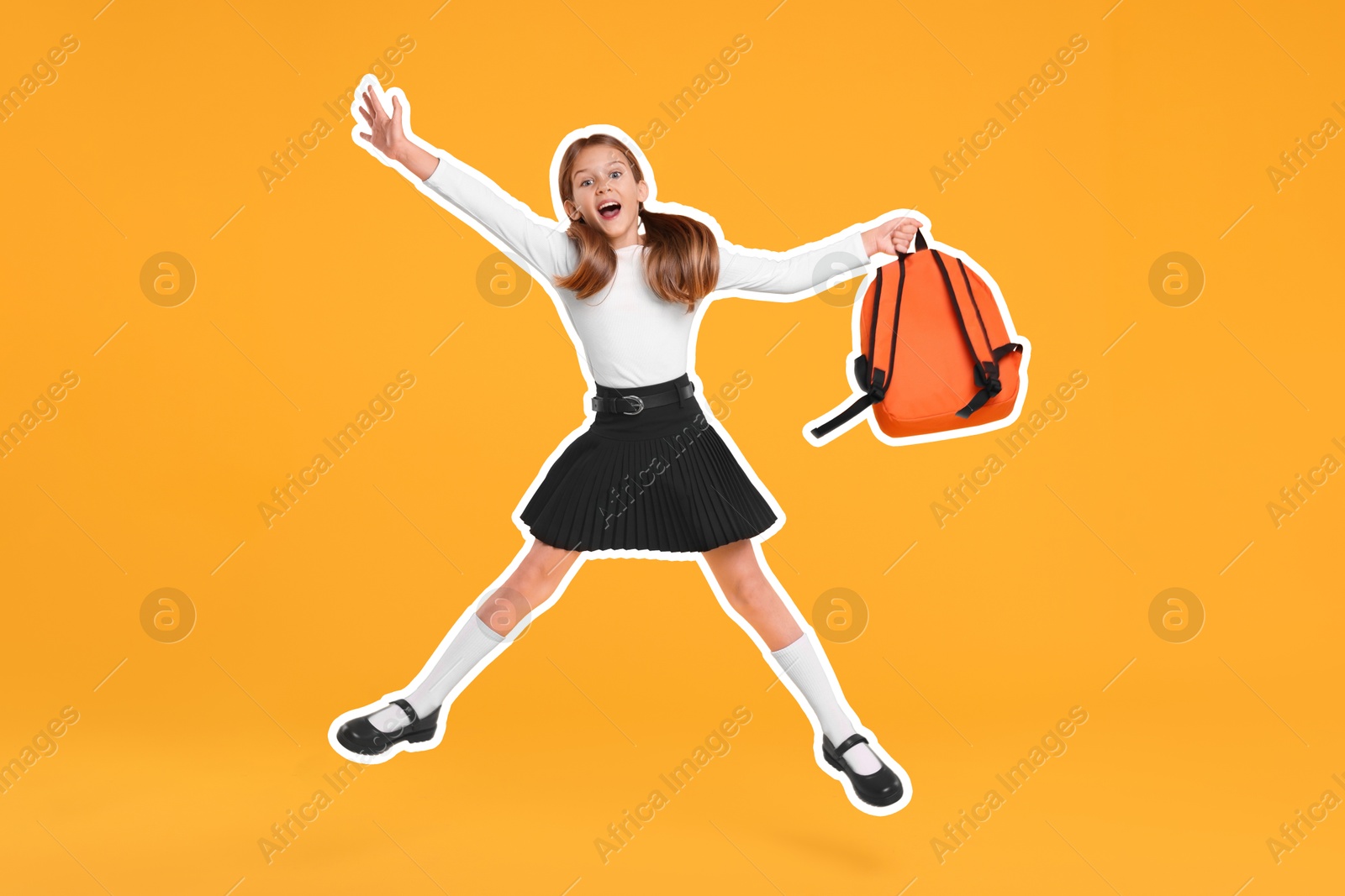 Image of Happy school child with backpack jumping on orange background