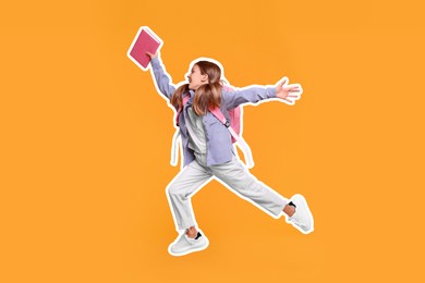 Image of Happy school child with book and backpack jumping on orange background