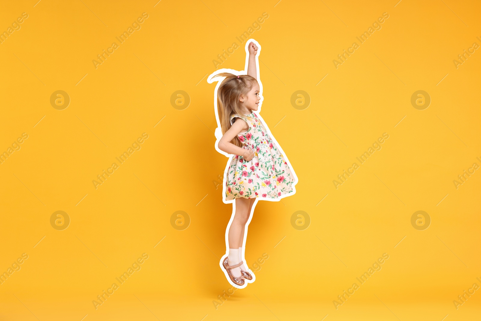 Image of Cute little girl jumping on orange background