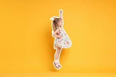 Cute little girl jumping on orange background