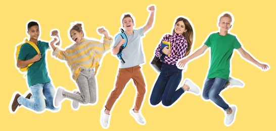 Cheerful teenagers jumping together on yellow background