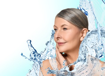 Beautiful mature woman and splashes of water on gradient background