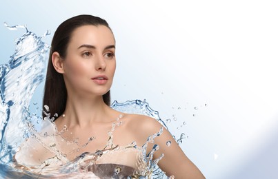 Beautiful woman and splashes of water on gradient background