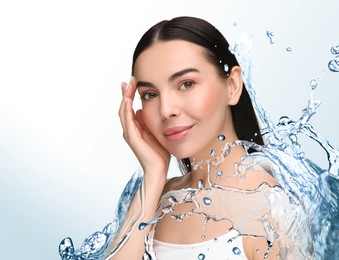 Image of Beautiful woman and splashes of water on gradient background