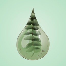 Image of Eucalyptus oil drop with branch inside on dark aquamarine background