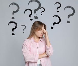Image of Amnesia. Worried woman and question marks on grey background