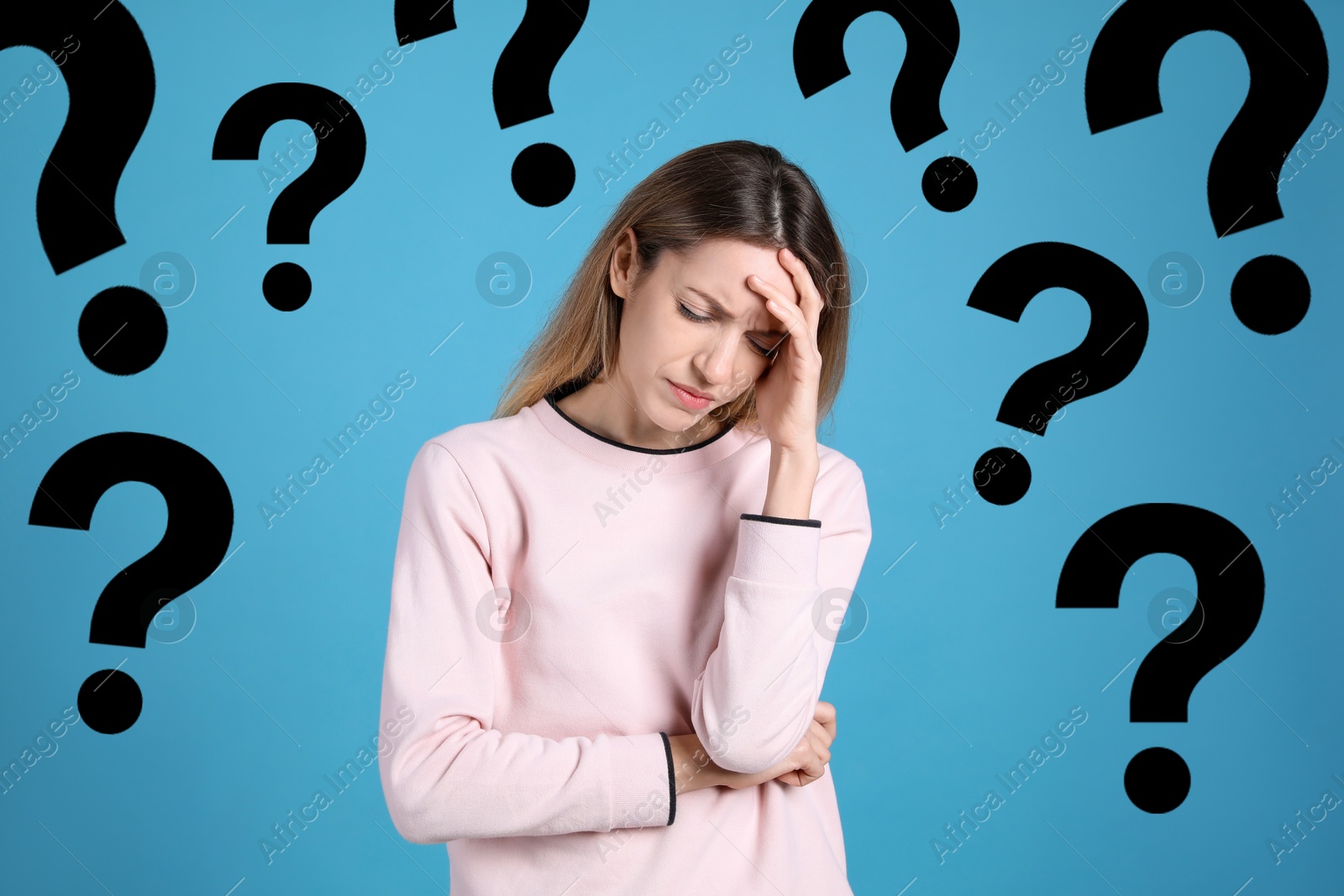 Image of Amnesia. Worried woman and question marks around her on light blue background