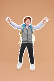 Image of Funny school child with backpack jumping on dark beige background