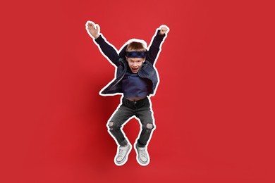 Happy little boy jumping on red background