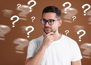 Thoughtful man and question marks on brown background