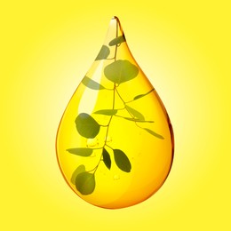 Image of Eucalyptus oil drop with branch inside on yellow background