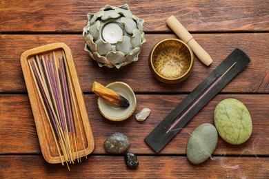 Photo of Flat lay composition with incense sticks on wooden table. Om ligature