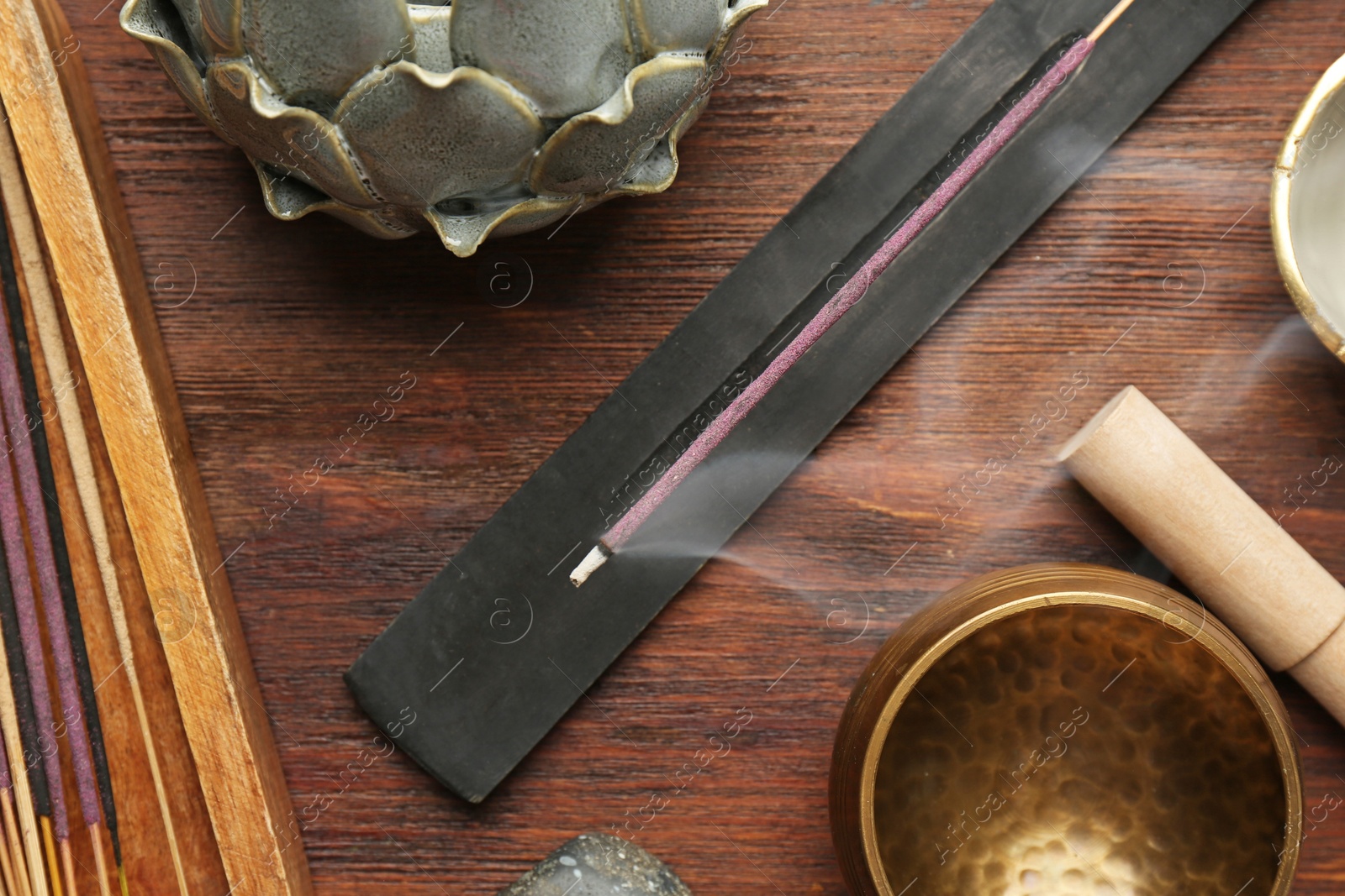 Photo of Flat lay composition with incense sticks on wooden table. Om ligature