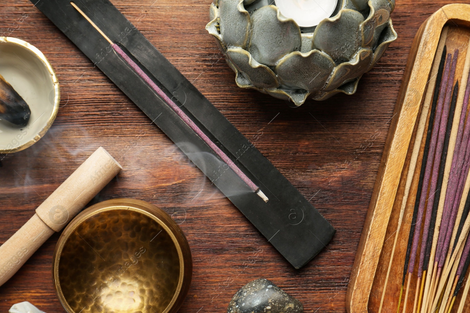 Photo of Flat lay composition with incense sticks on wooden table. Om ligature