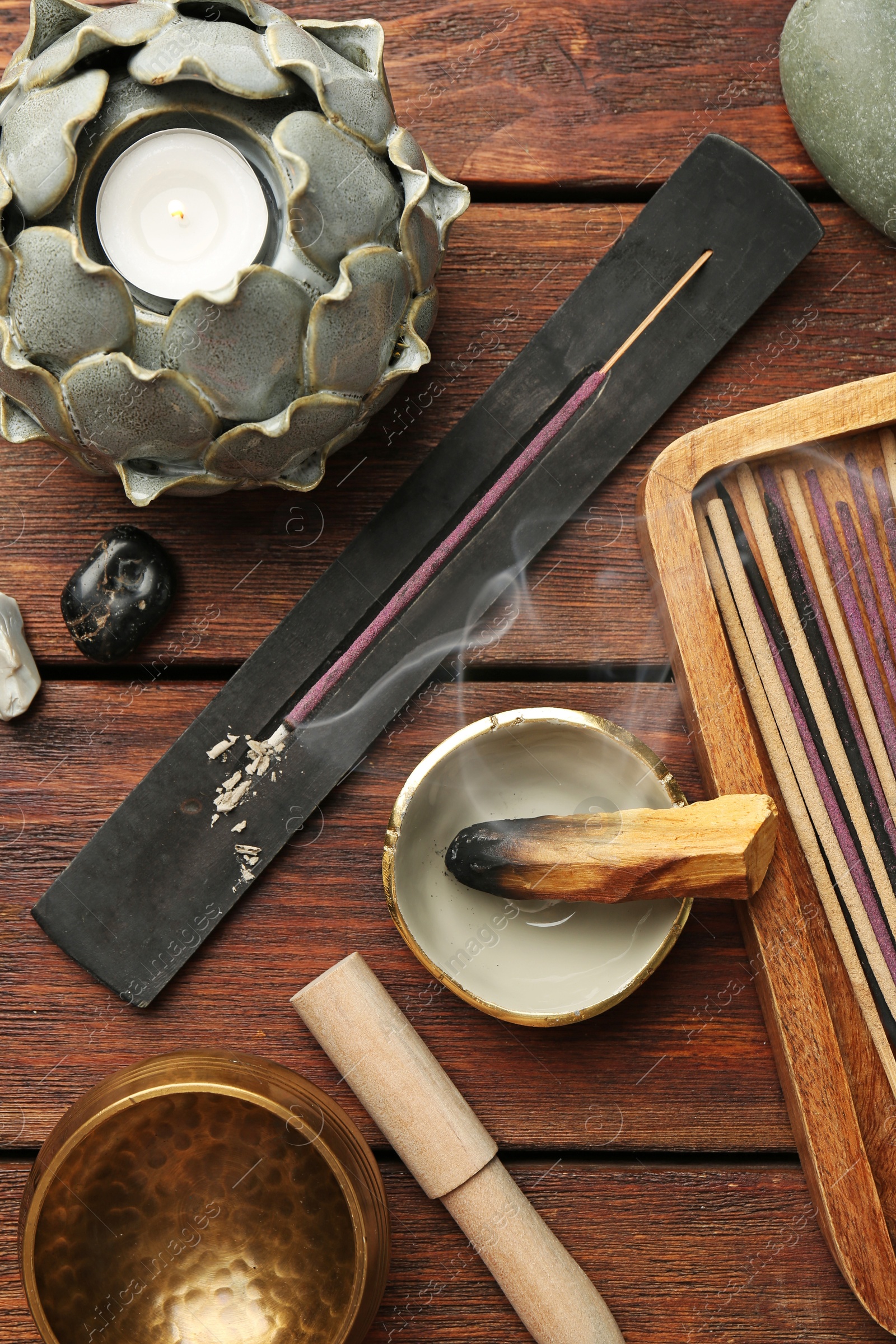 Photo of Flat lay composition with incense sticks on wooden table. Om ligature