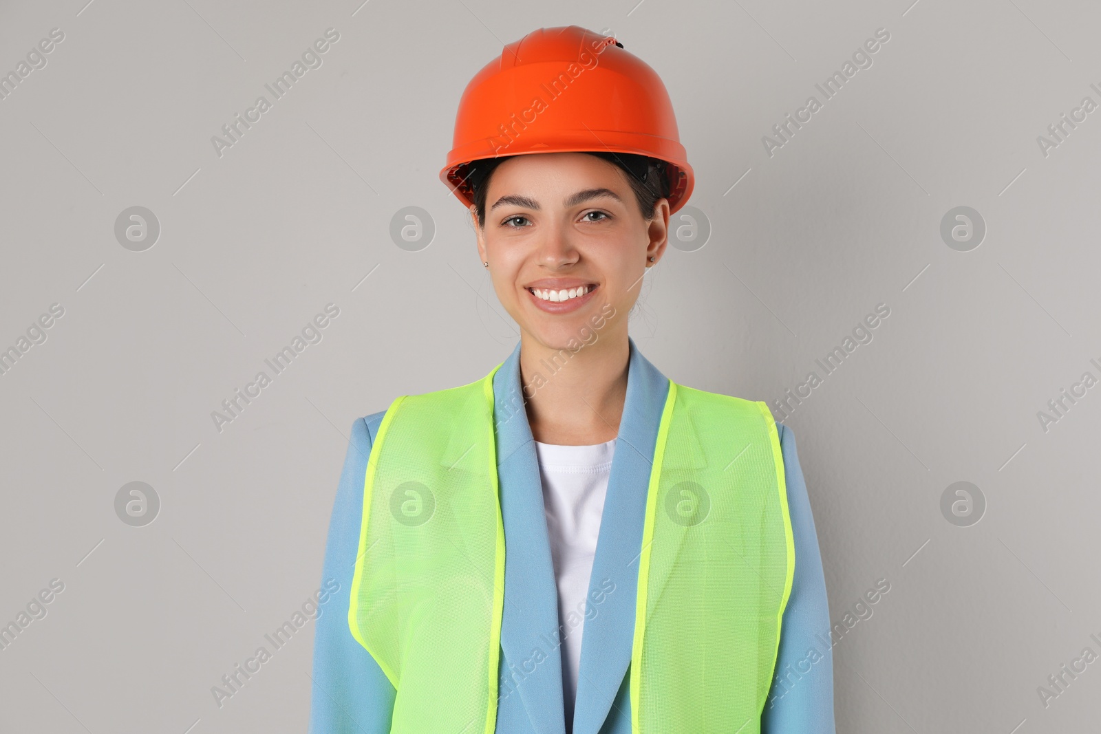 Photo of Engineer in hard hat on grey background