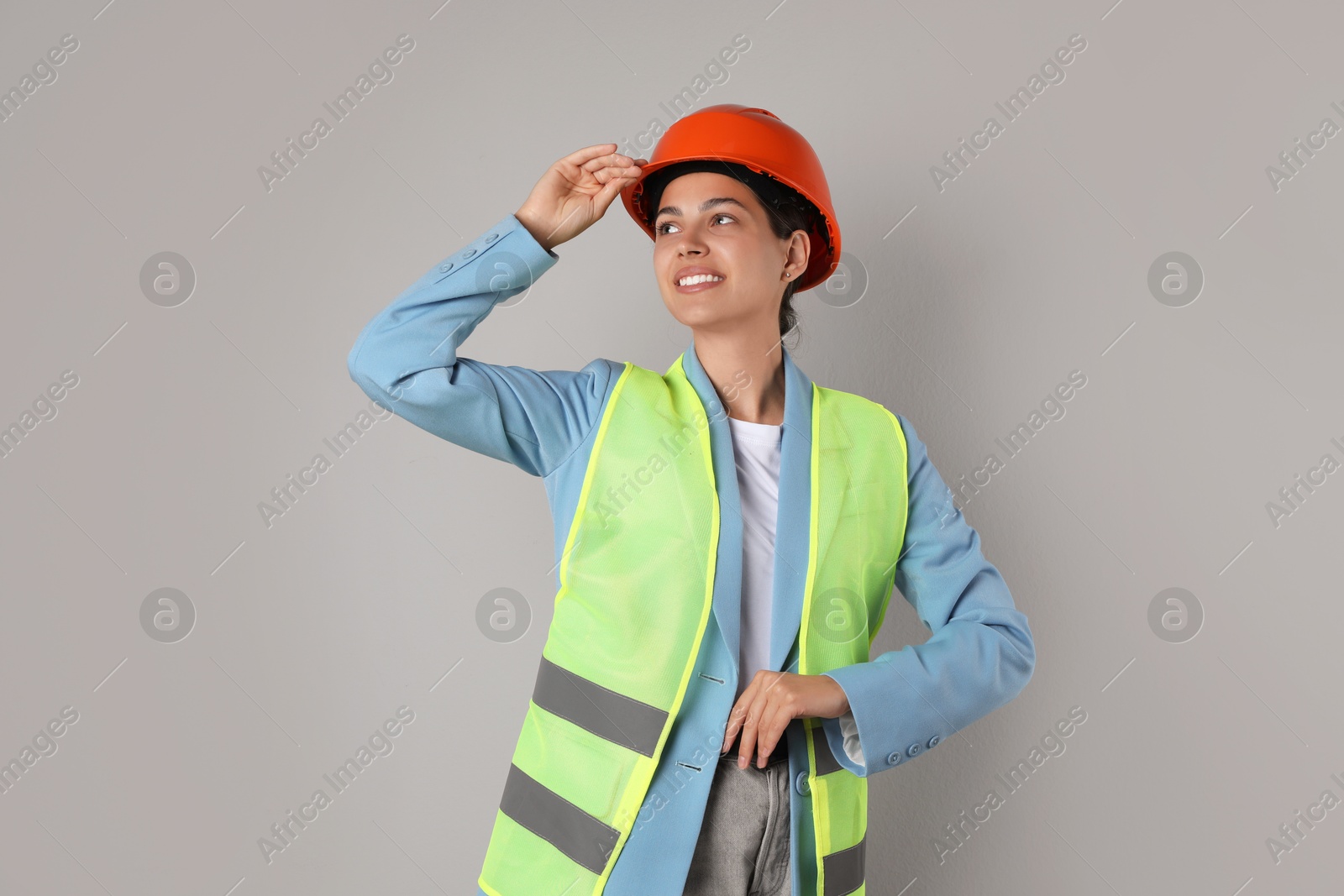 Photo of Engineer in hard hat on grey background