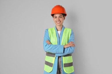 Photo of Engineer in hard hat on grey background