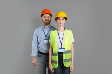 Photo of Engineers in hard hats on grey background