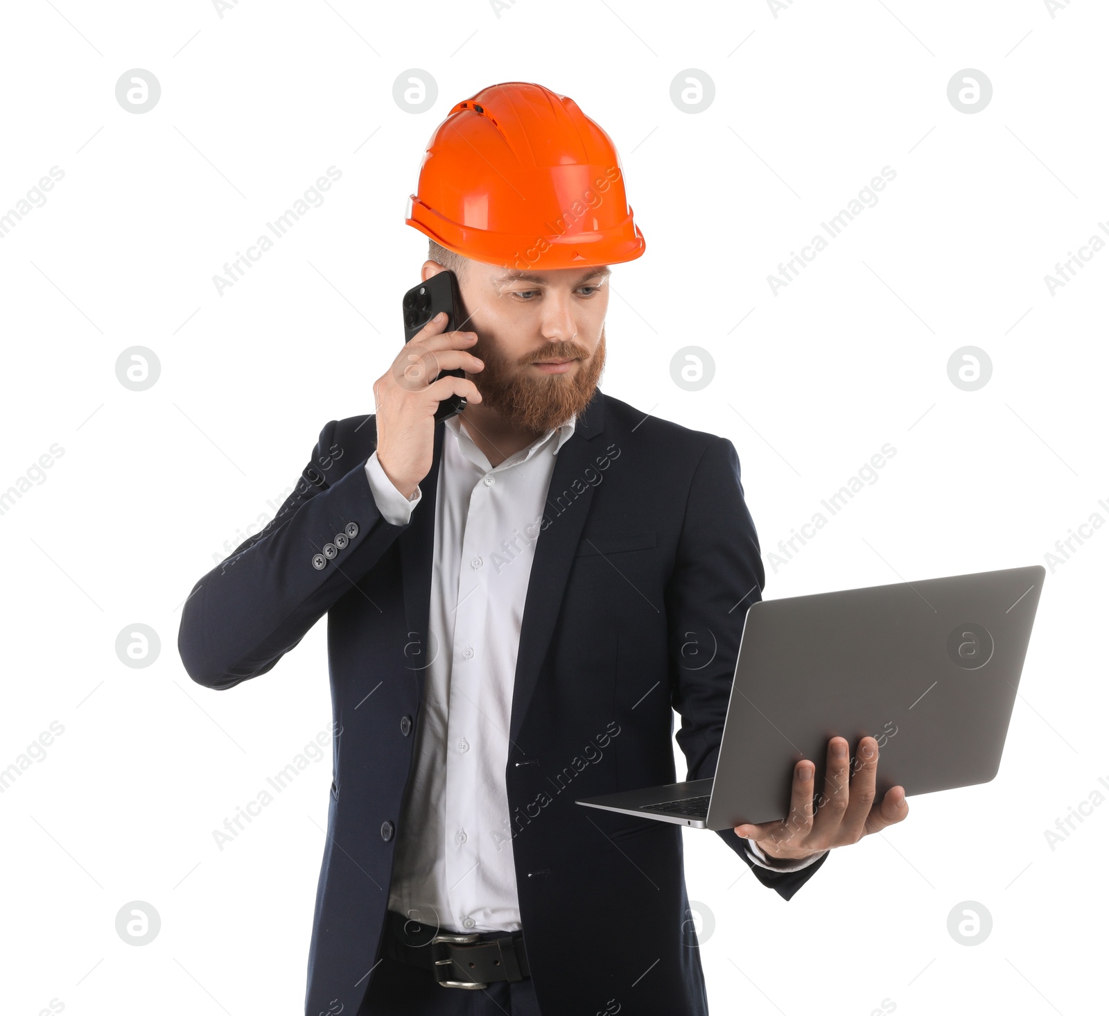 Photo of Engineer in hard hat with laptop talking on smartphone against white background