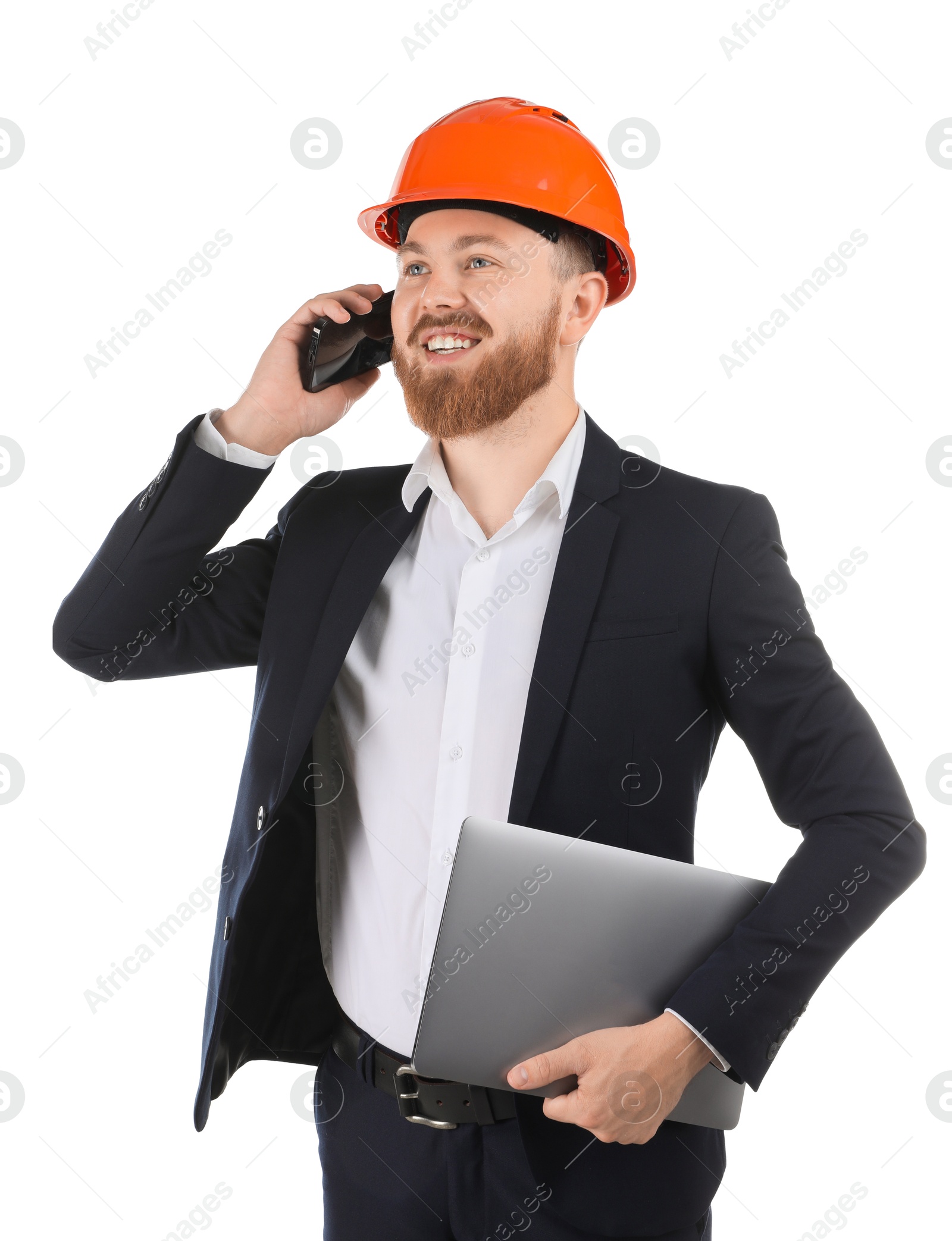 Photo of Engineer in hard hat with laptop talking on smartphone against white background