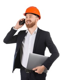 Engineer in hard hat with laptop talking on smartphone against white background