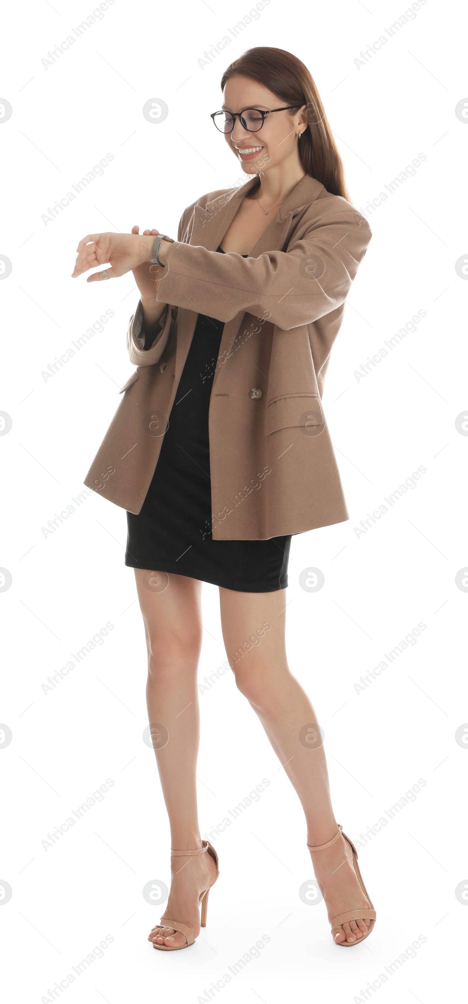 Photo of Beautiful woman in stylish brown jacket, glasses and black dress checking time on white background