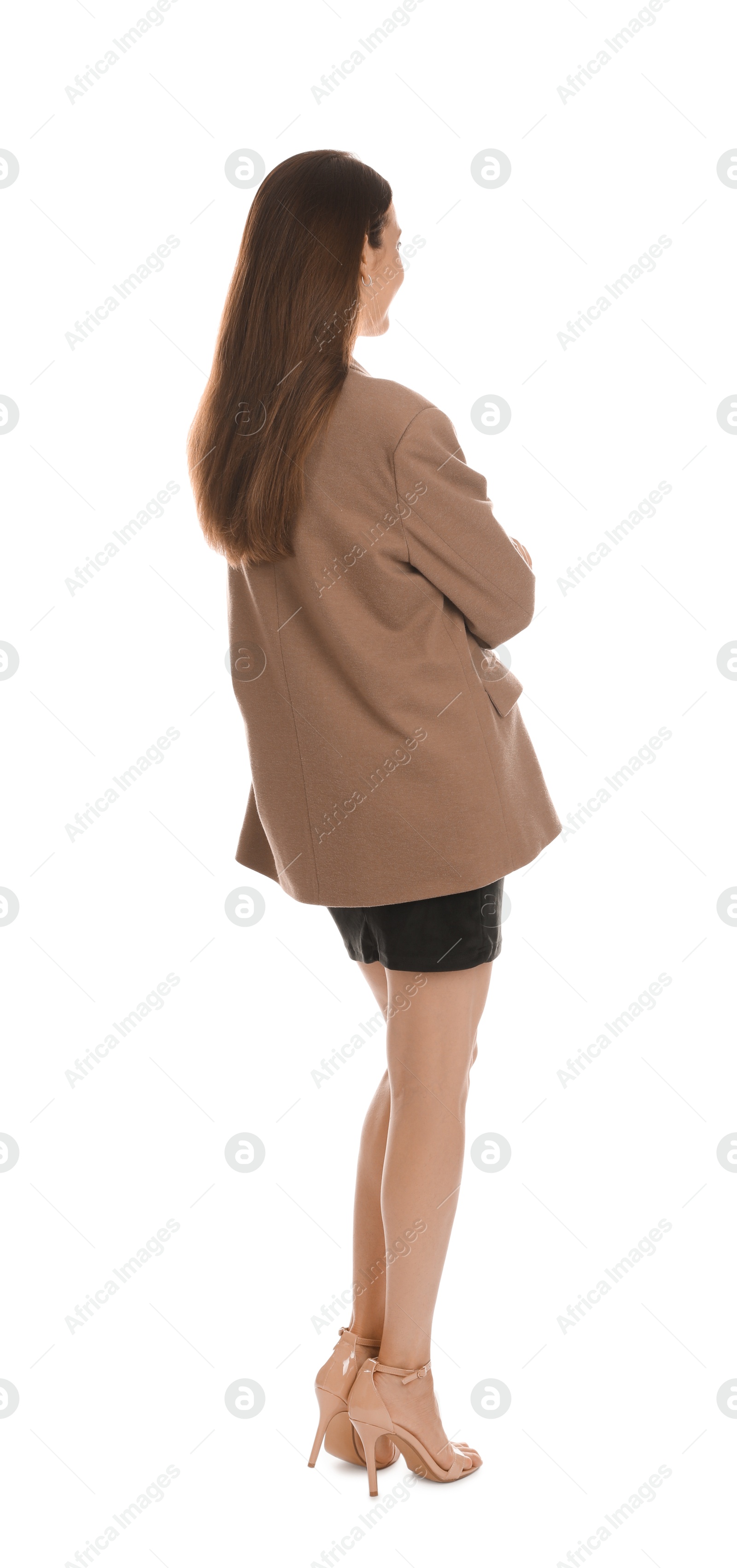 Photo of Young woman in stylish brown jacket and black dress on white background, back view