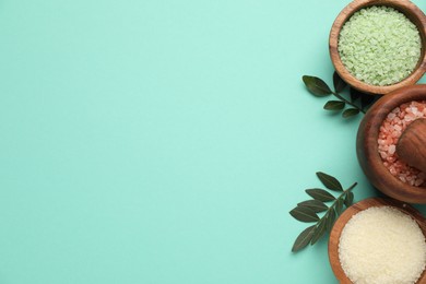 Photo of Different cosmetic products and green leaves on turquoise background, flat lay. Space for text