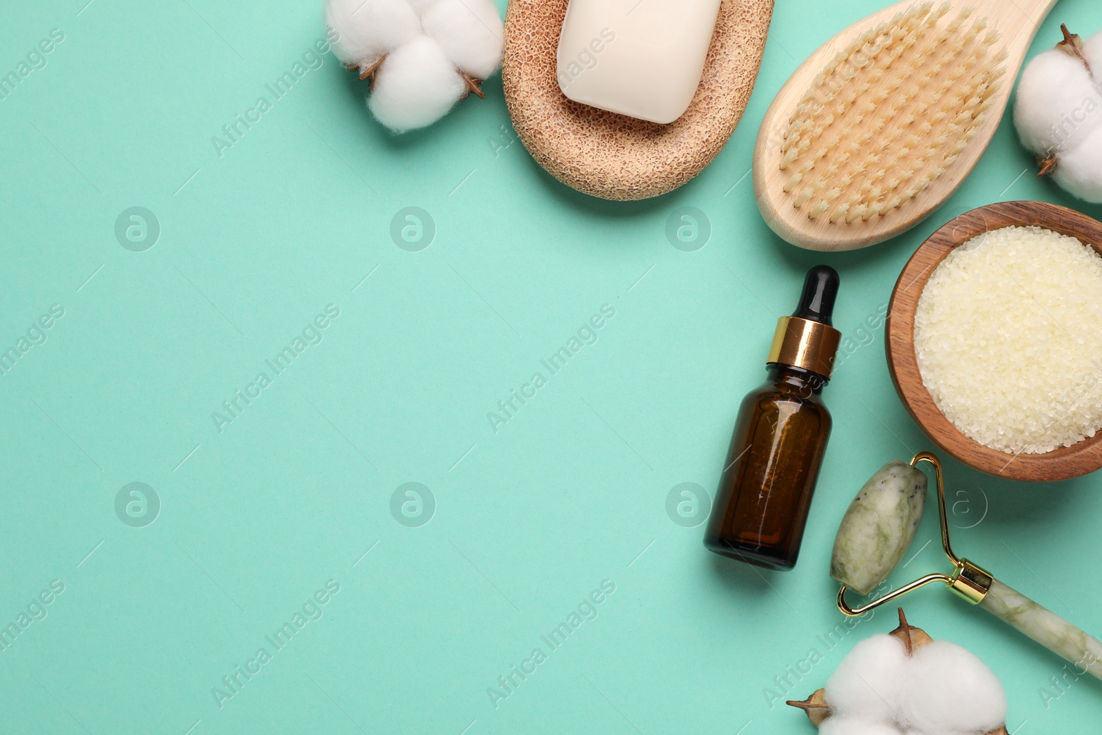 Photo of Different cosmetic products and cotton flowers on turquoise background, flat lay. Space for text