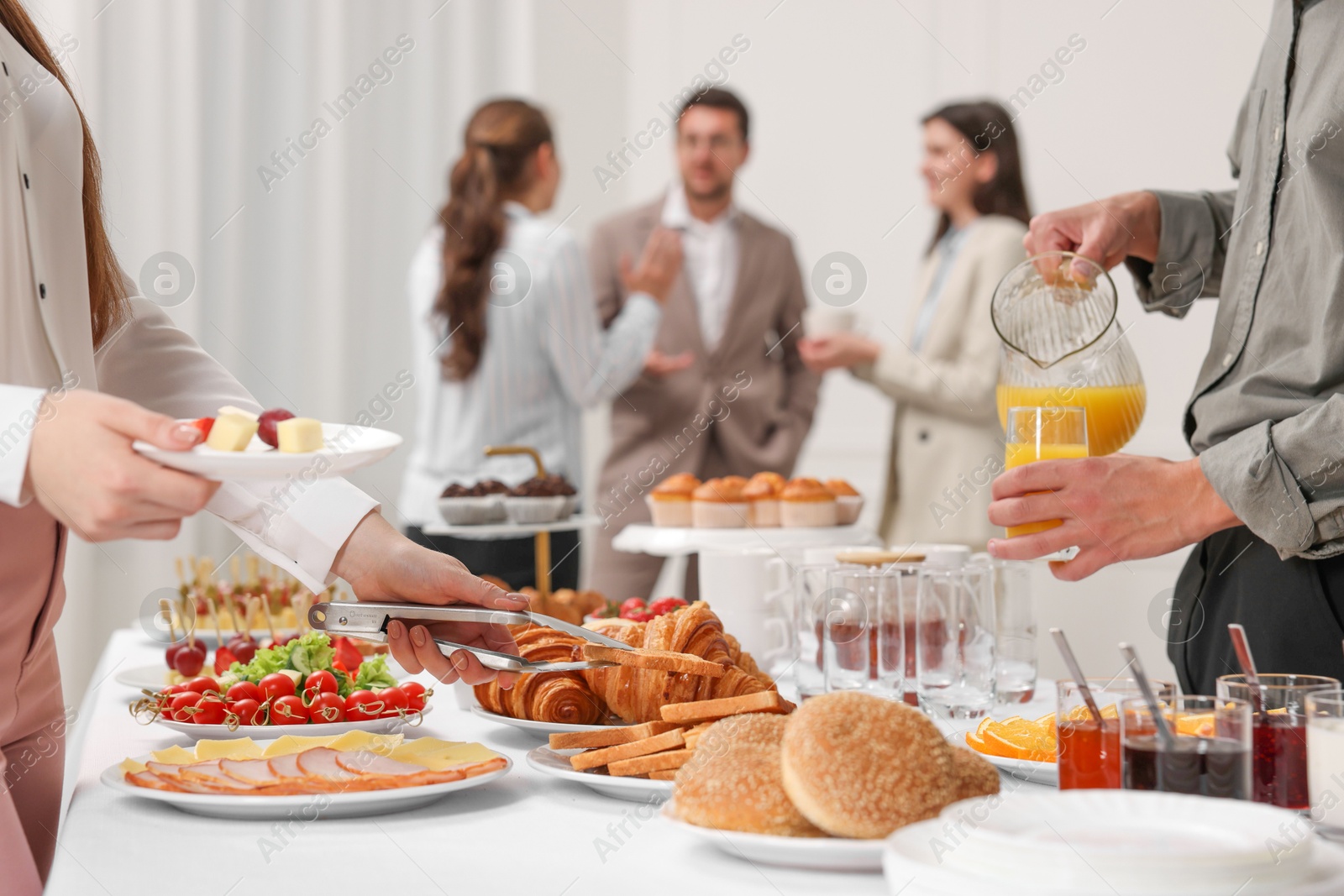 Photo of Coworkers having business lunch in restaurant, closeup