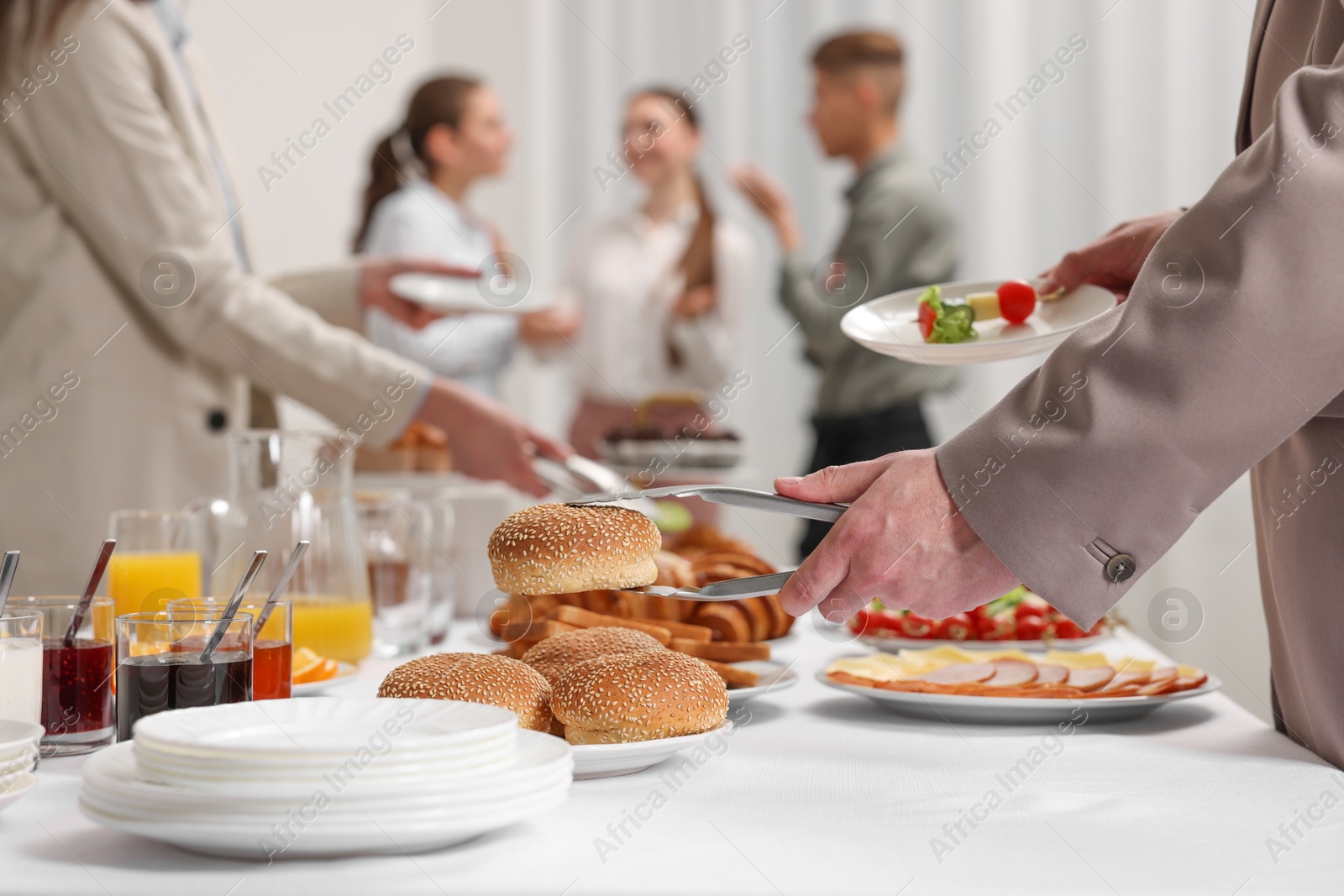 Photo of Coworkers having business lunch in restaurant, closeup