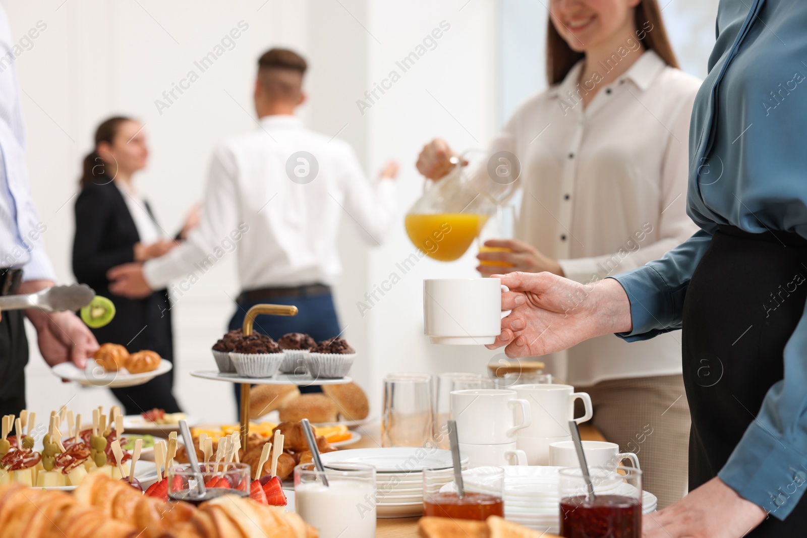 Photo of Coworkers having business lunch in restaurant, closeup