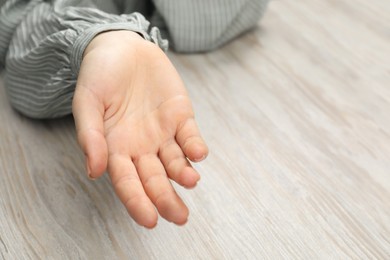 Photo of Chiromancy and foretelling. Woman showing palm at white wooden table, closeup. Space for text